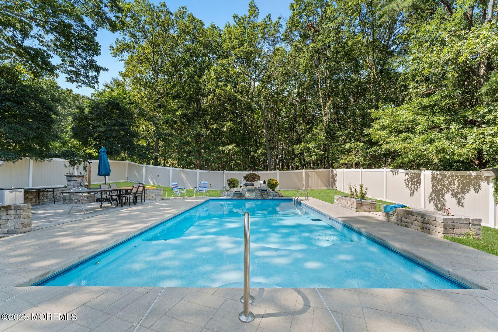 24 Friendship Road Howell, NJ 07731 - Photo 30 of 34 a swimming pool with some trees in the background