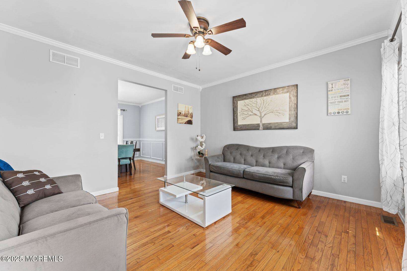 24 Friendship Road Howell, NJ 07731 - Photo 3 of 34 a living room with furniture and a wooden floor