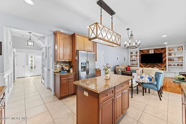 a view of a kitchen area kitchen island dining table and stainless steel appliances