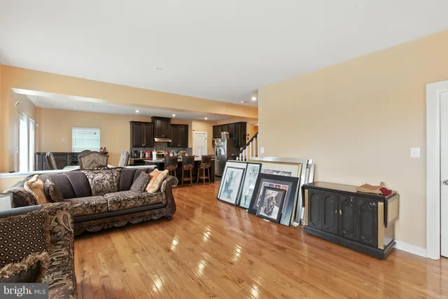 a living room with furniture and kitchen view