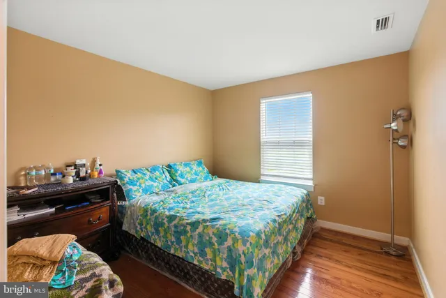 a bedroom with a bed and a dresser in it