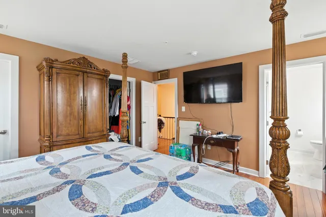 a bed room with a bed a television and a lamp