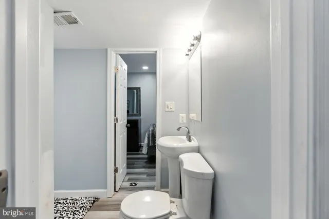 a bedroom with a bed and a mirror