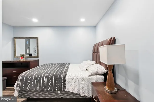 a bedroom with a bed and a lamp