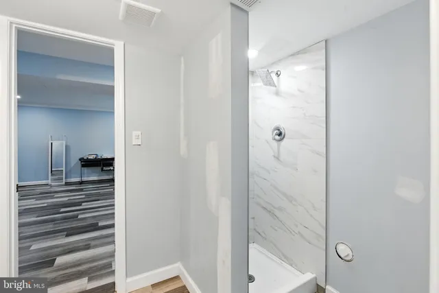 a view of a roof deck with table and chairs and wooden floor