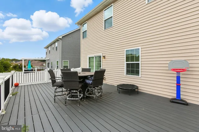 a view of a deck with table and chairs and wooden floor
