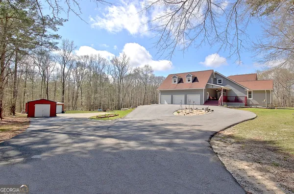 a front view of a house with a yard and a garage