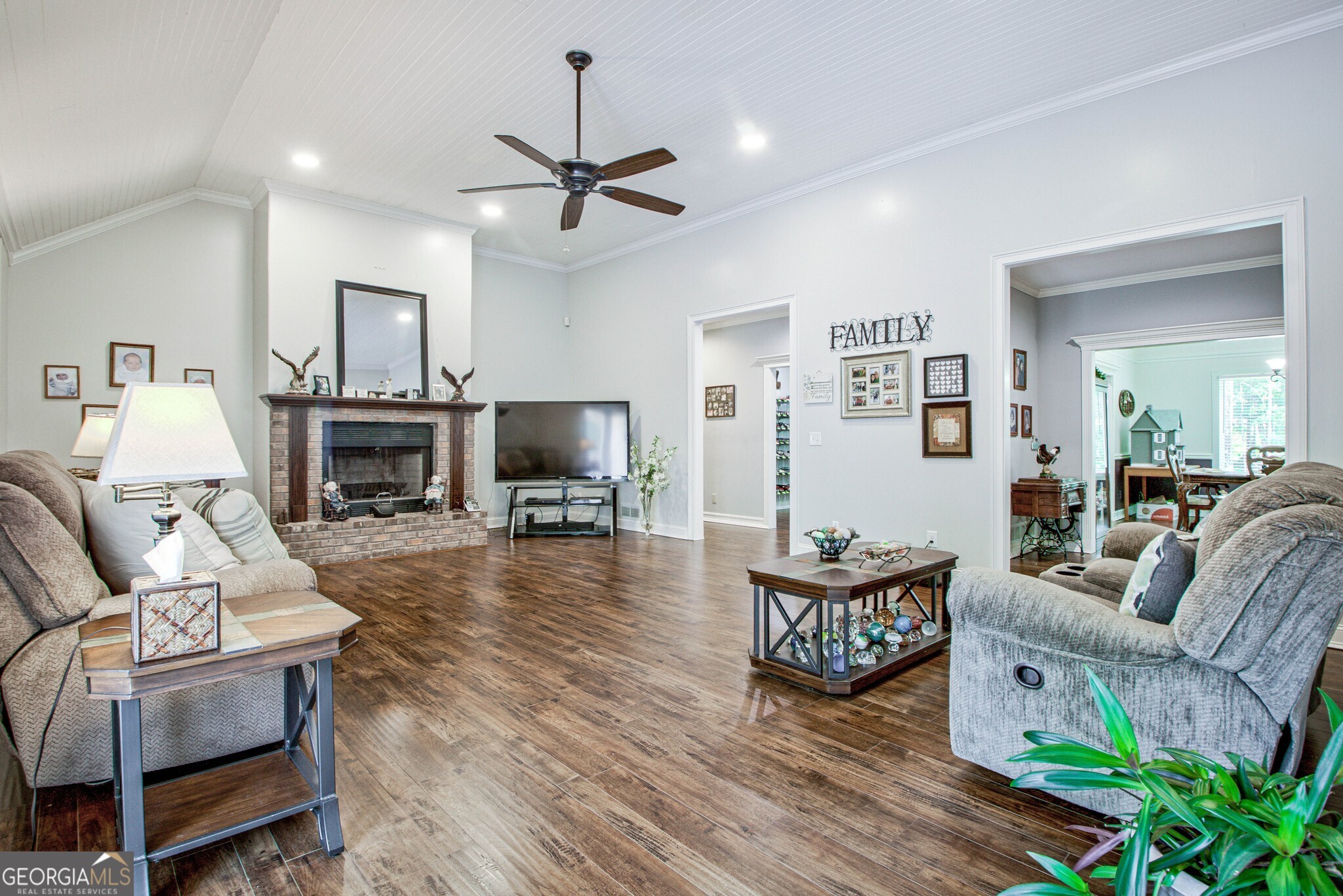 967 Tope Road Sharpsburg, GA 30277 - Photo 20 of 98 a living room with furniture a flat screen tv and a fireplace
