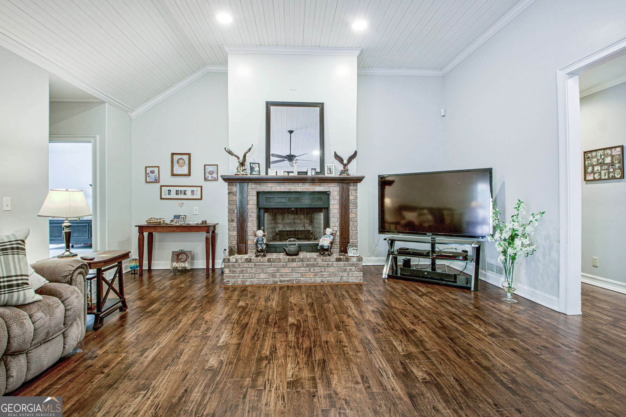 967 Tope Road Sharpsburg, GA 30277 - Photo 23 of 98 a living room with furniture a flat screen tv and a fireplace