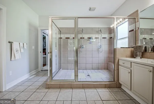 a kitchen with stainless steel appliances a table chairs and a refrigerator
