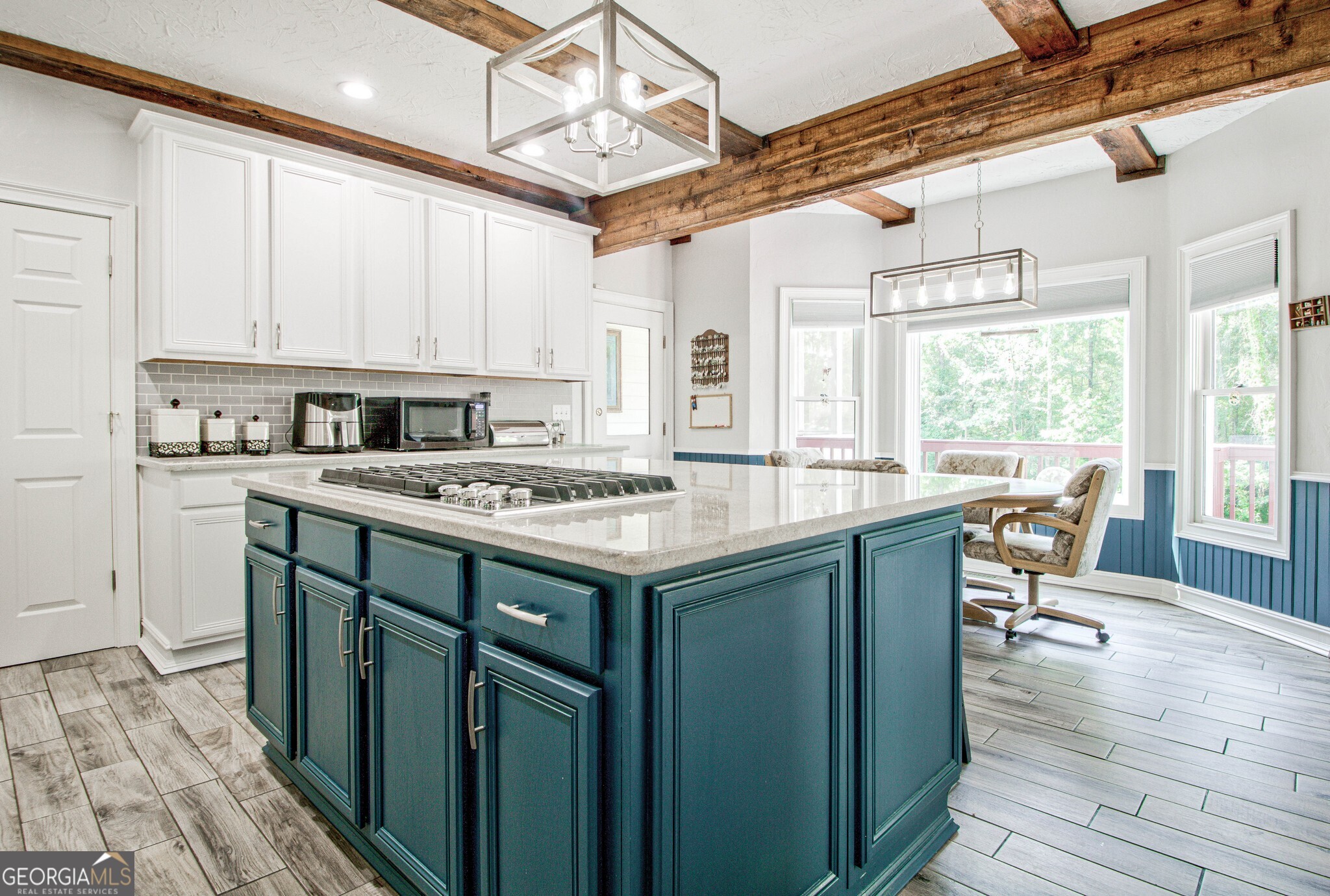 967 Tope Road Sharpsburg, GA 30277 - Photo 34 of 98 a kitchen with sink cabinets and wooden floor