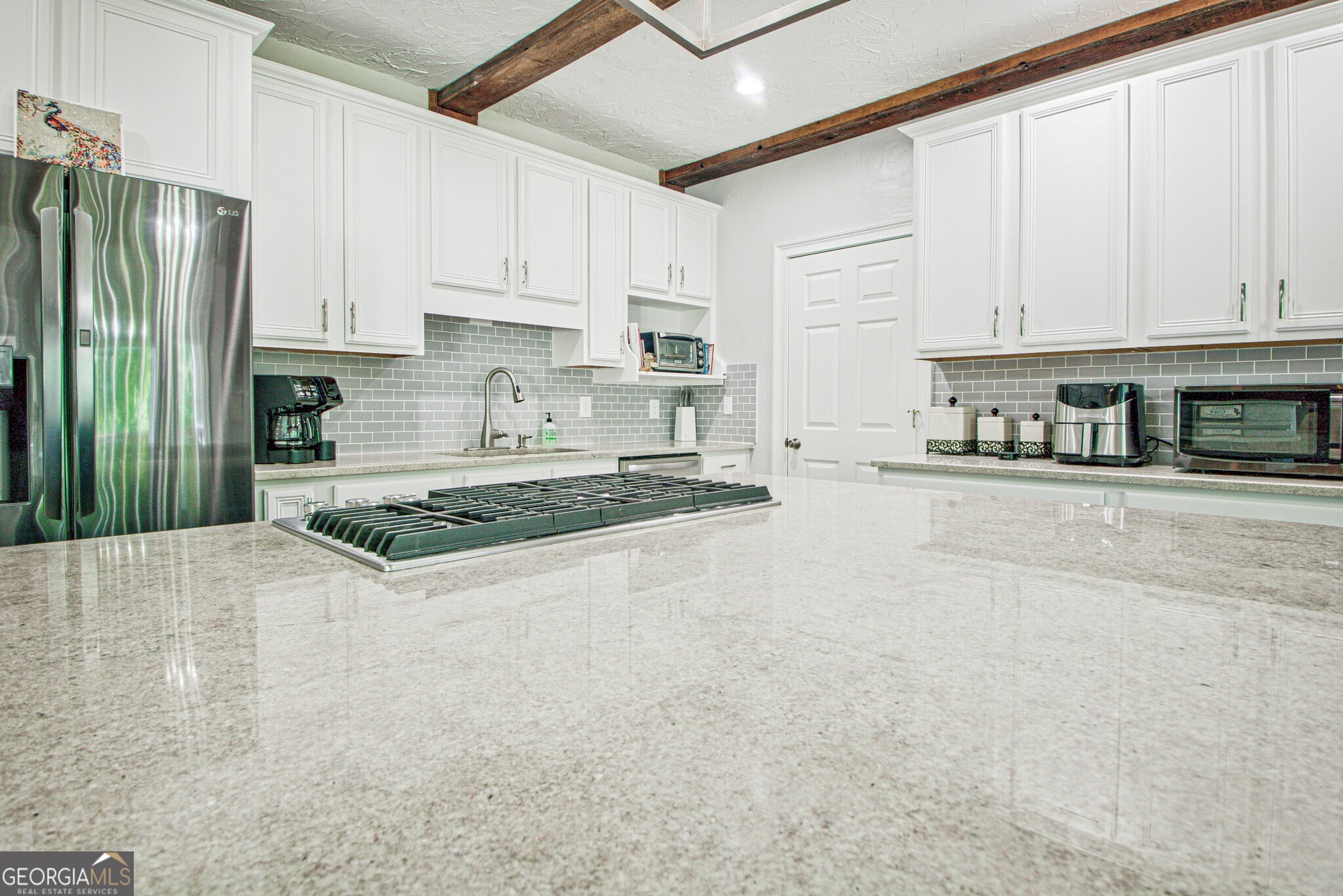 967 Tope Road Sharpsburg, GA 30277 - Photo 39 of 98 a kitchen with stainless steel appliances granite countertop a refrigerator sink and cabinets