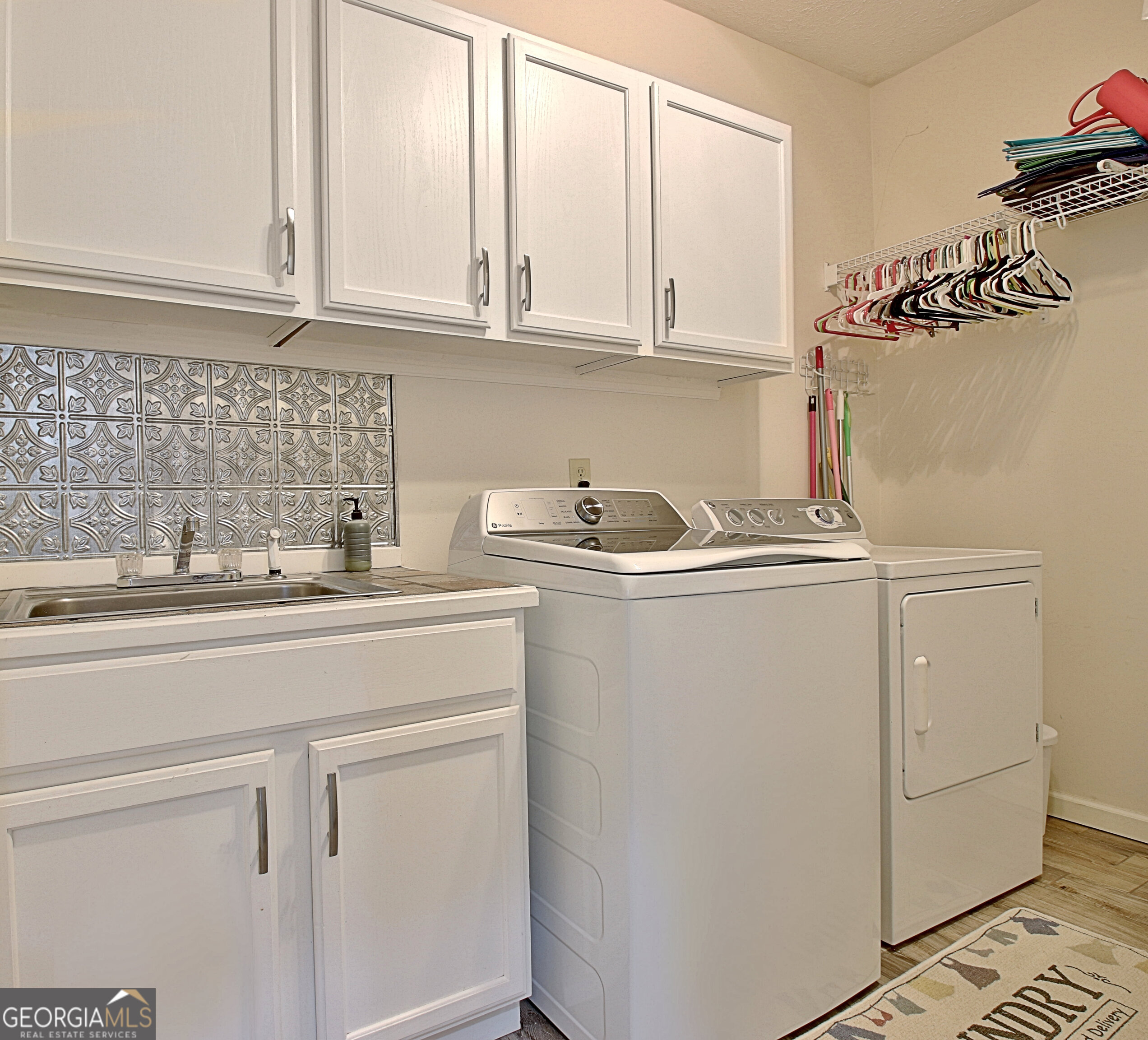 967 Tope Road Sharpsburg, GA 30277 - Photo 41 of 98 a kitchen with stainless steel appliances granite countertop white cabinets sink and dishwasher