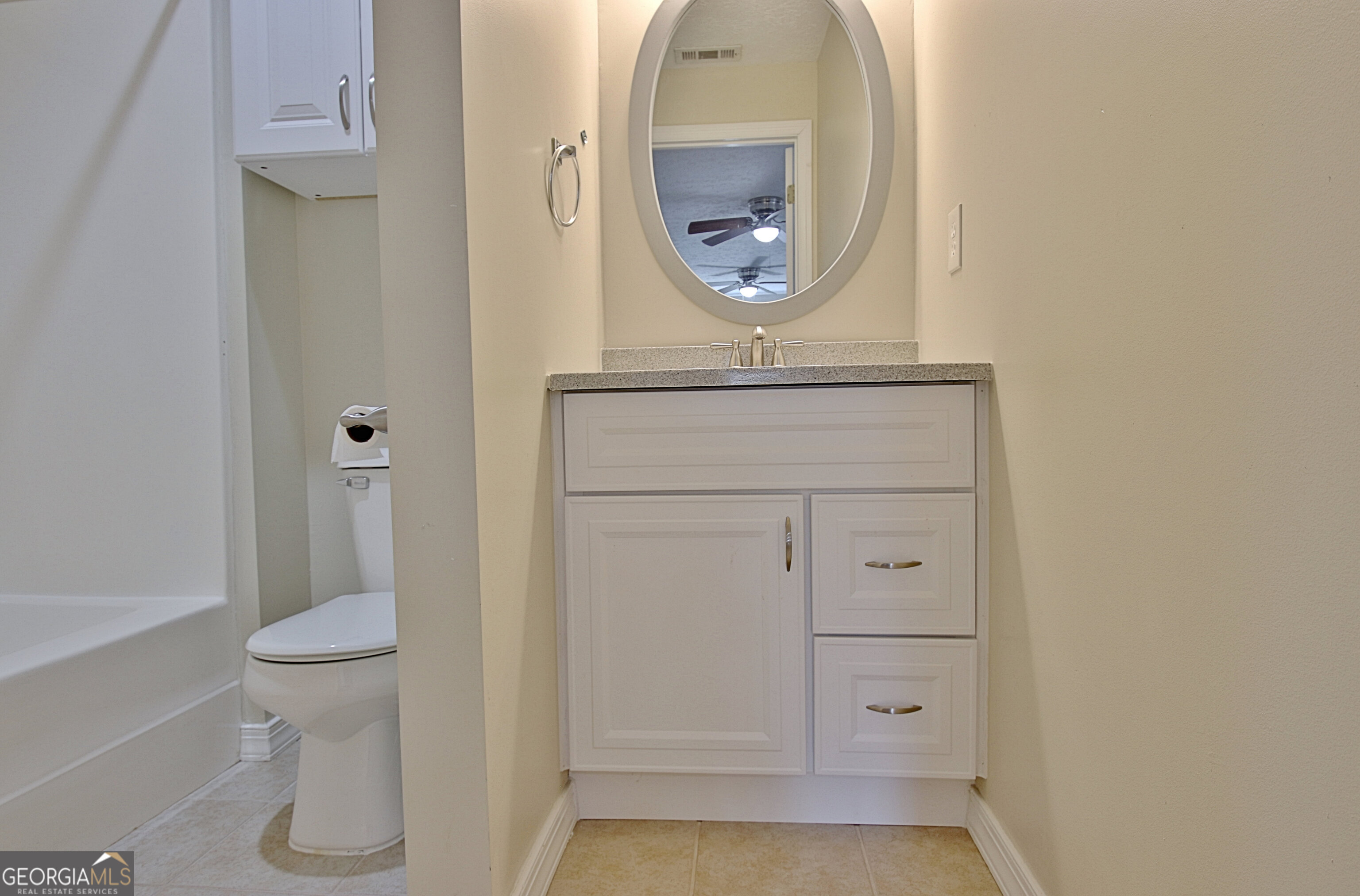 967 Tope Road Sharpsburg, GA 30277 - Photo 45 of 98 a bathroom with a toilet and a mirror
