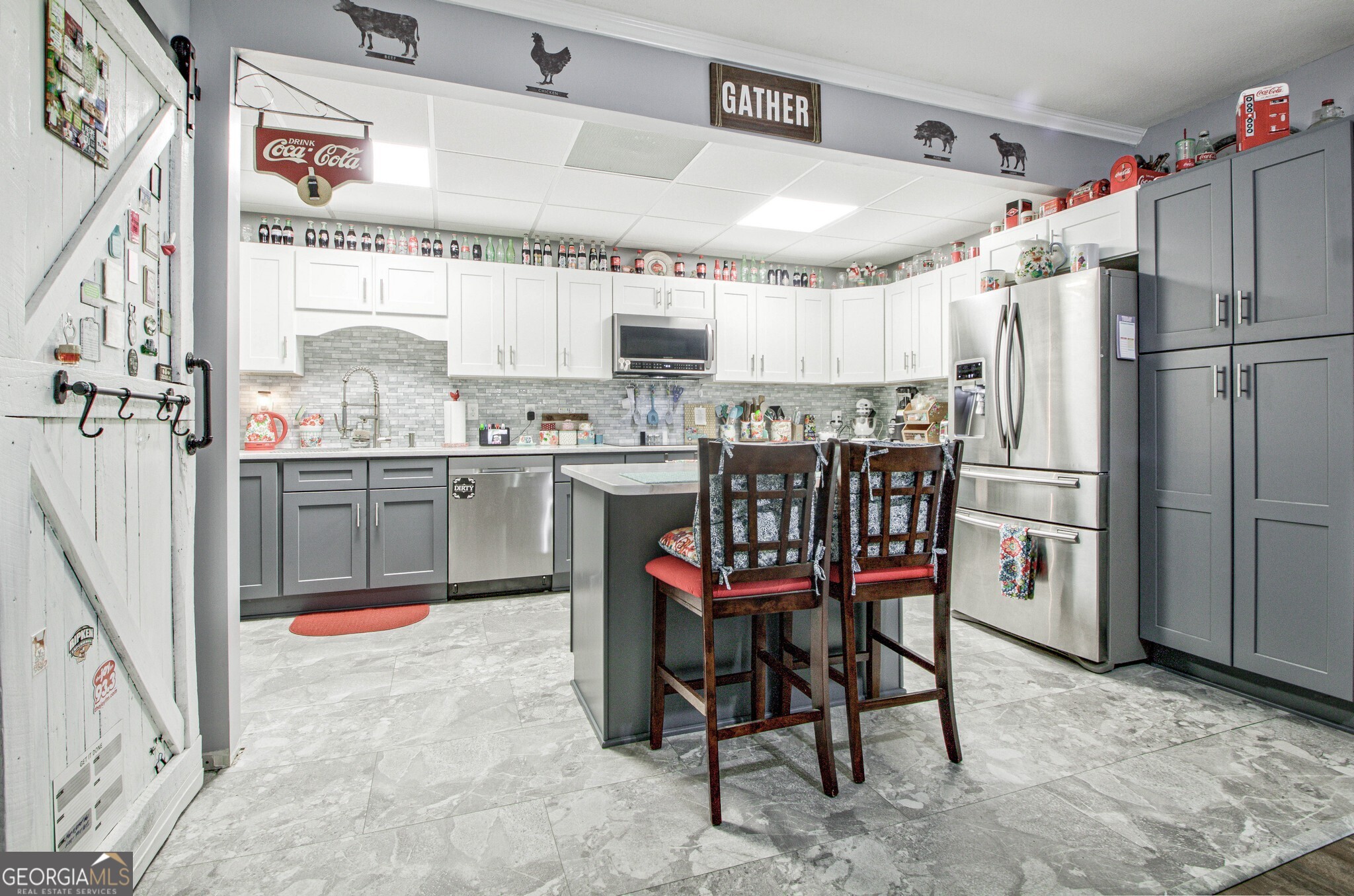 967 Tope Road Sharpsburg, GA 30277 - Photo 57 of 98 a kitchen with stainless steel appliances a table chairs and a refrigerator