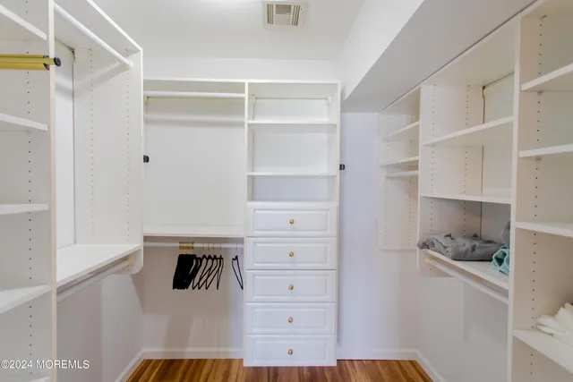 a view of a bedroom with closet and cabinet