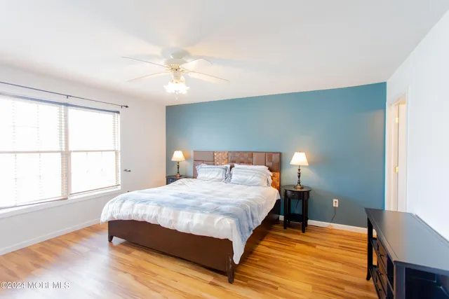 a bedroom with a large bed and a large window