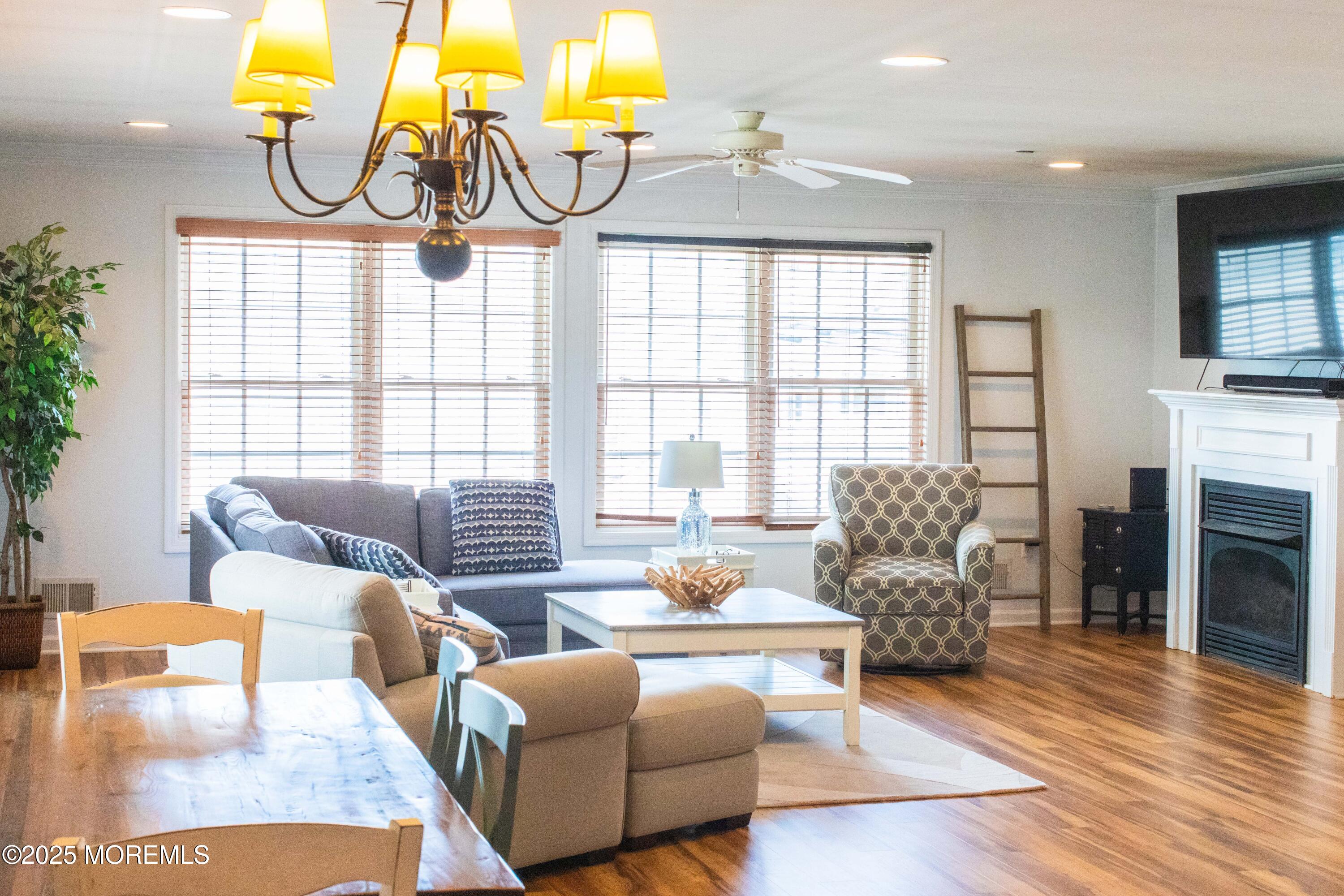 580 East Main Street, Unit 3 Manasquan, NJ 08736 - Photo 40 of 41 a living room with fireplace furniture and a floor to ceiling window