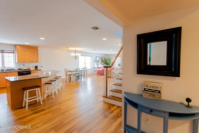a room with lots of wooden furniture and a view of living room