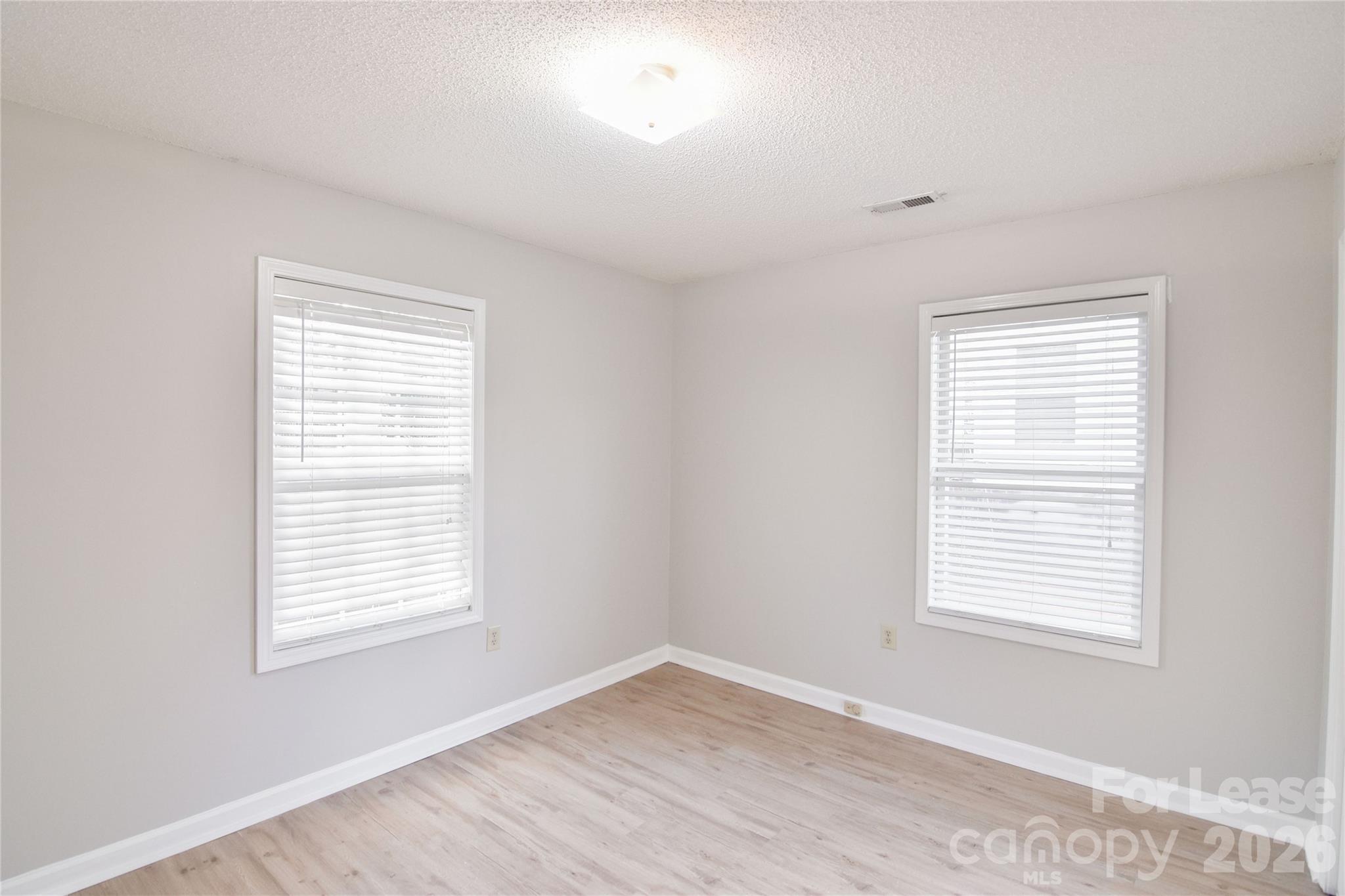 110 Pratt Street Belmont, NC 28012 - Photo 15 of 18 a view of an empty room with wooden floor and a window