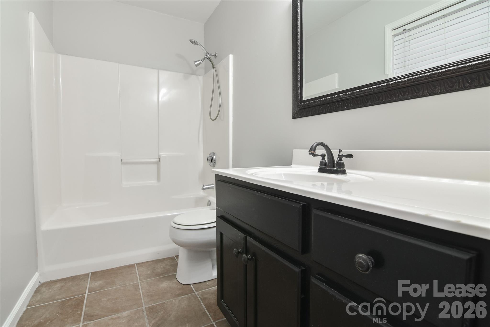 110 Pratt Street Belmont, NC 28012 - Photo 5 of 18 a bathroom with a sink a toilet and shower