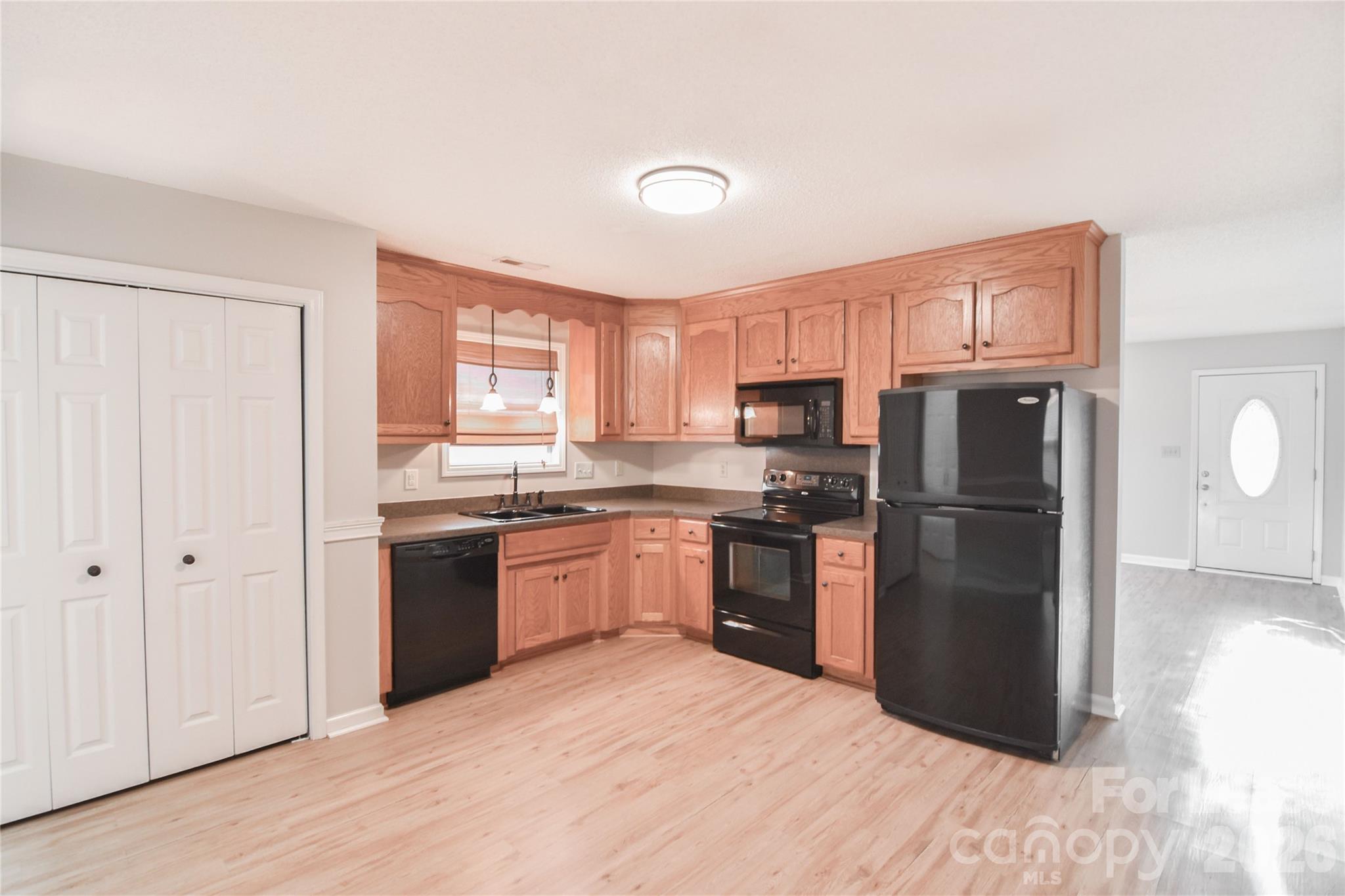 110 Pratt Street Belmont, NC 28012 - Photo 6 of 18 a kitchen with granite countertop stainless steel appliances a refrigerator cabinets and wooden floor