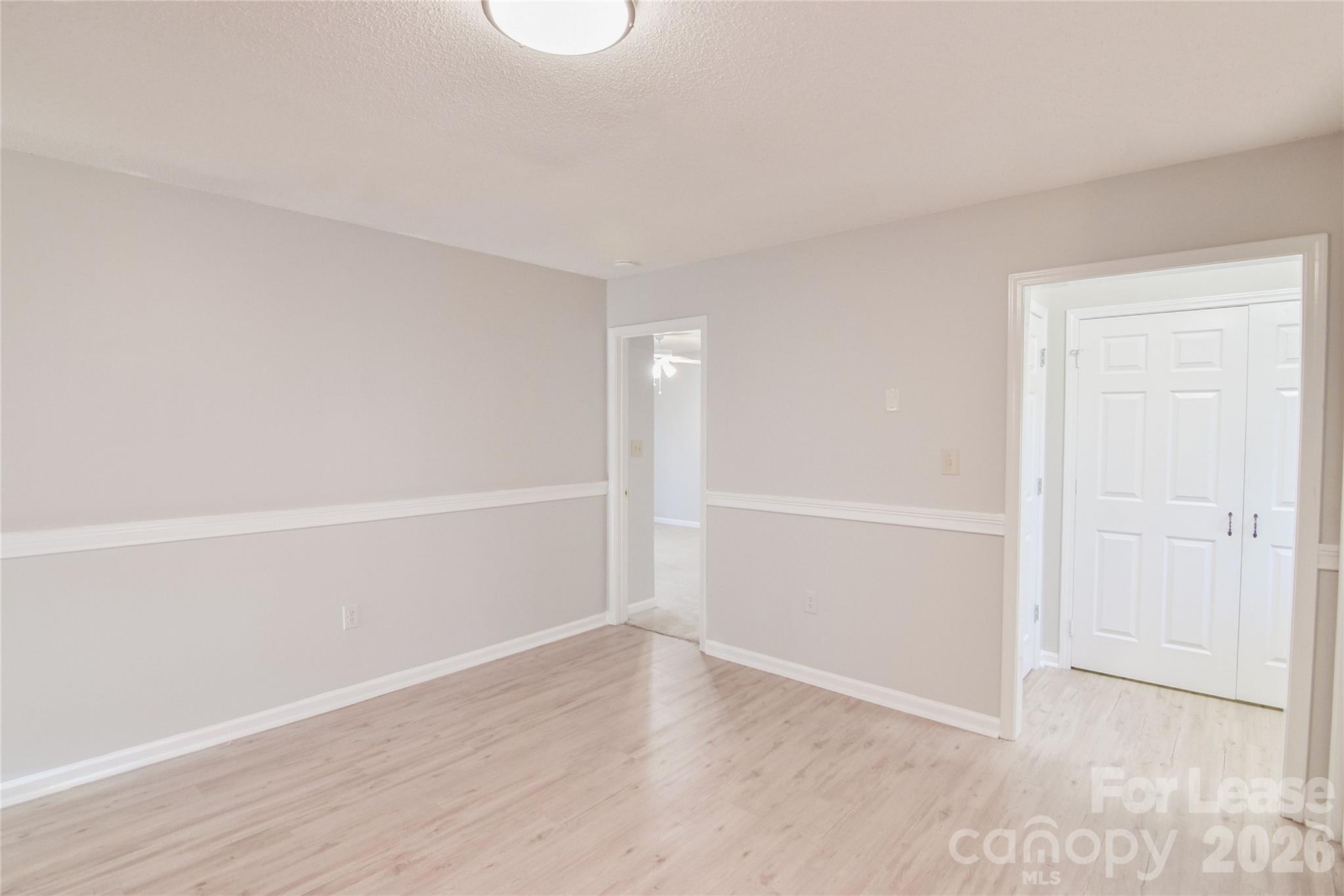 110 Pratt Street Belmont, NC 28012 - Photo 9 of 18 an empty room with wooden floor and white walls
