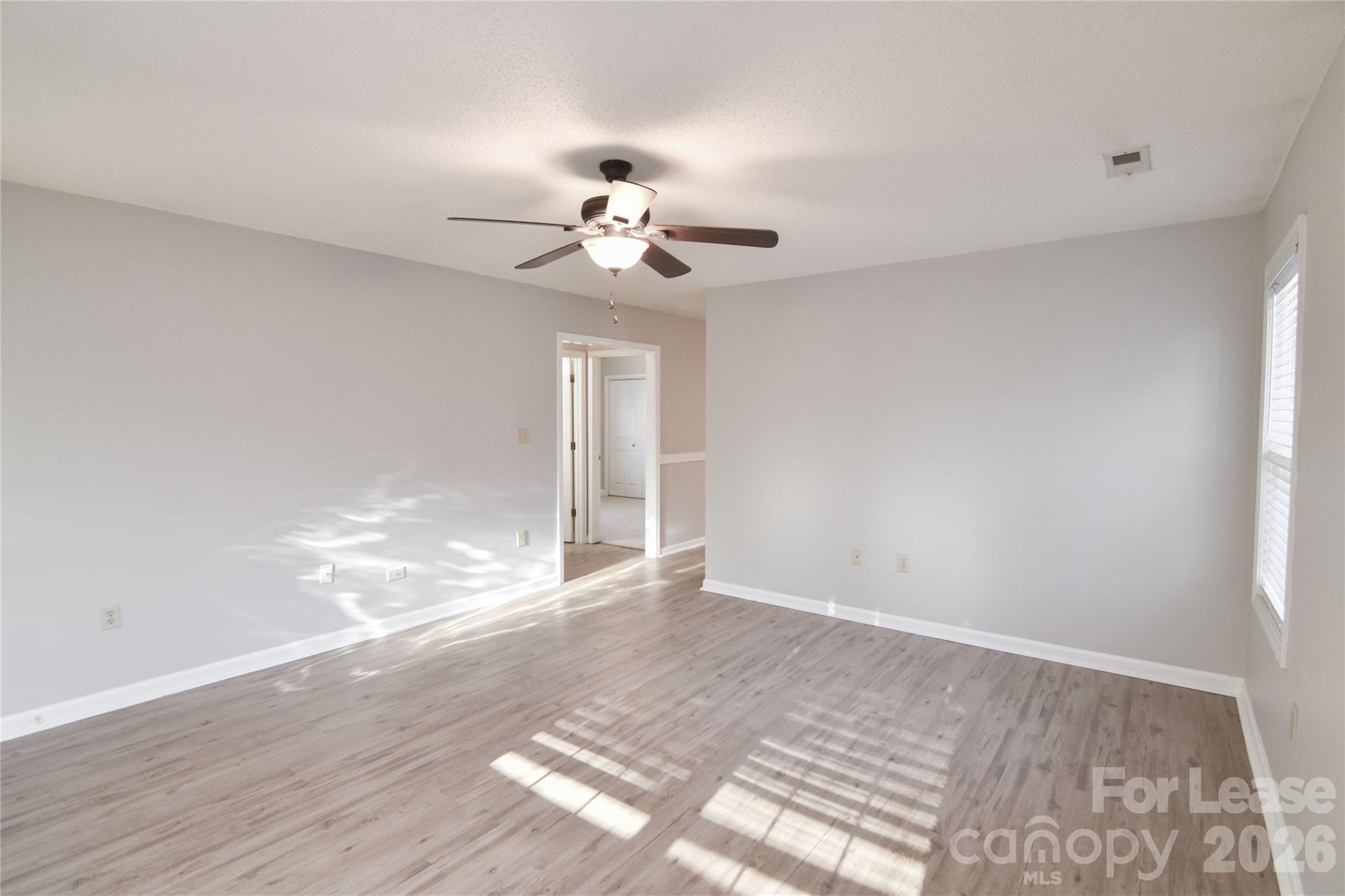 110 Pratt Street Belmont, NC 28012 - Photo 10 of 18 a view of an empty room with wooden floor and a window