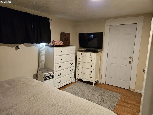 a bedroom with a bed and a dresser