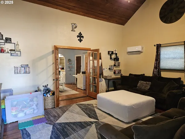 a living room with furniture and wooden floor