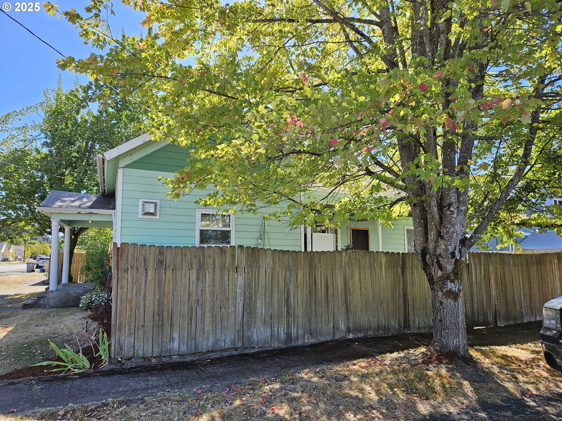 1040 Southeast 6th Avenue Albany, OR 97321 - Photo 36 of 48 a view of a wooden fence next to a large tree