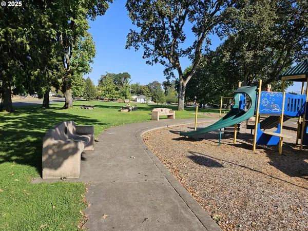 a view of a park with swings and slides