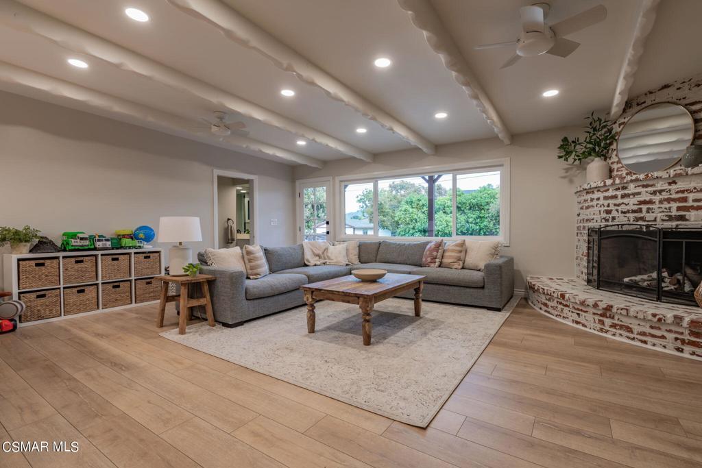 75 Neish Street Camarillo, CA 93010 - Photo 18 of 42 a living room with furniture a fireplace a rug and a floor to ceiling window