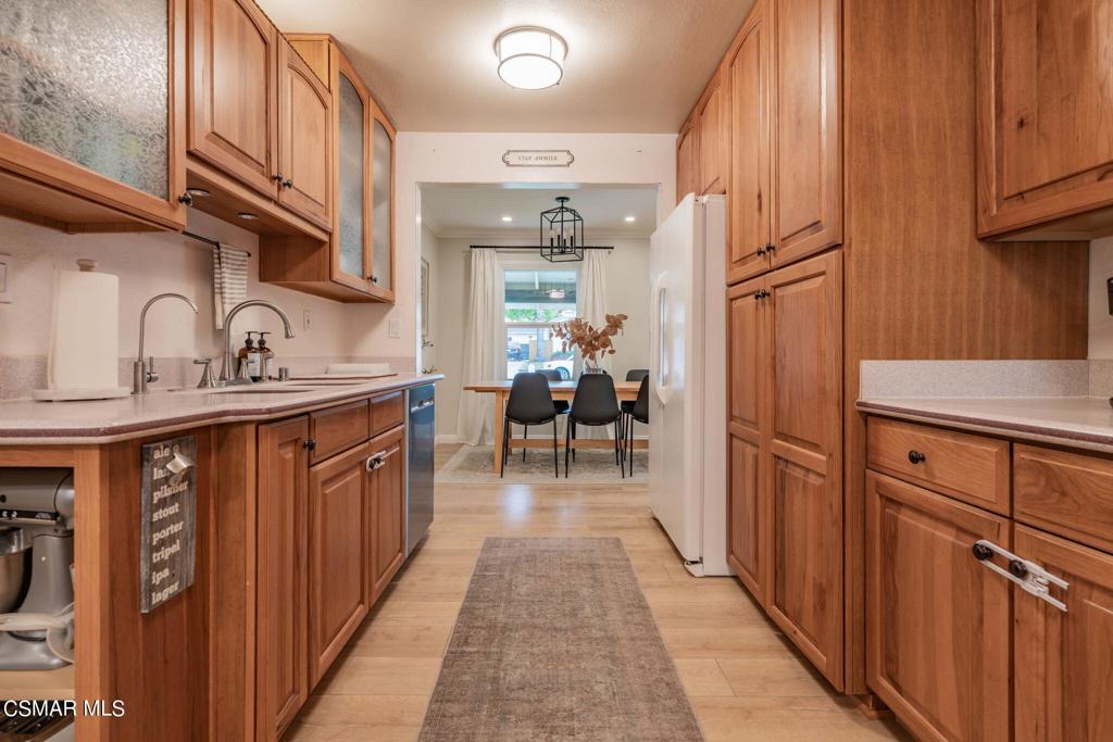 75 Neish Street Camarillo, CA 93010 - Photo 2 of 42 a kitchen with stainless steel appliances granite countertop a refrigerator a sink dishwasher and wooden cabinets with wooden floor