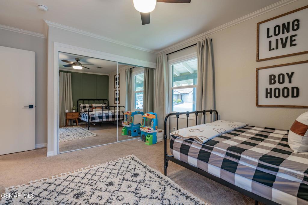 75 Neish Street Camarillo, CA 93010 - Photo 28 of 42 a bedroom with a bed and a chandelier