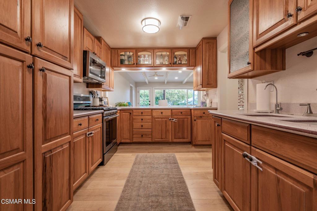75 Neish Street Camarillo, CA 93010 - Photo 3 of 42 a kitchen with stainless steel appliances granite countertop a sink and cabinets