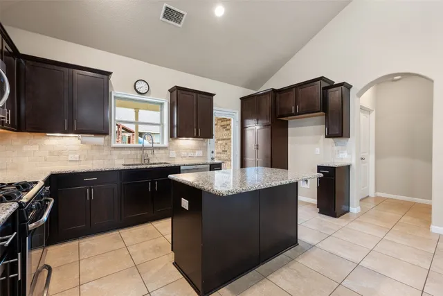 a kitchen with stainless steel appliances a sink counter space and cabinets