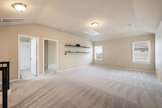 a view of a kitchen with a sink and a refrigerator