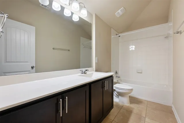 a bathroom with a double vanity sink a toilet and a mirror