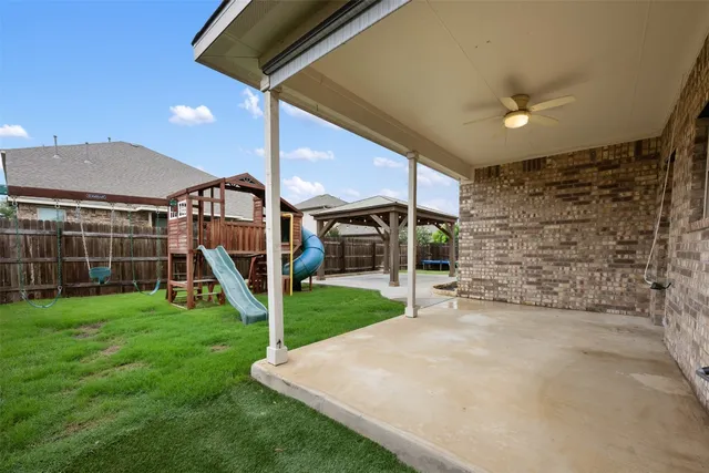 a view of a house with a big yard and potted plants