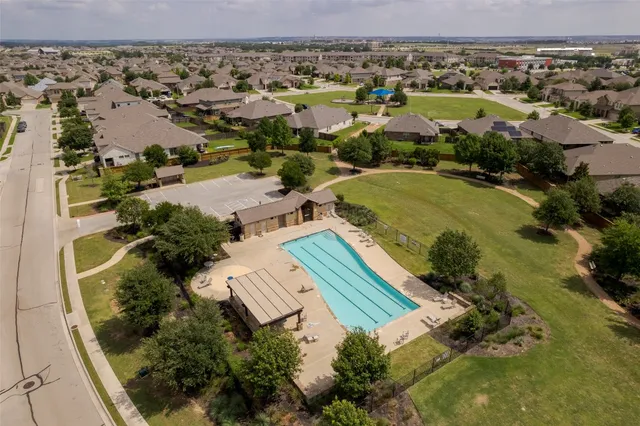 an aerial view of a house with a swimming pool