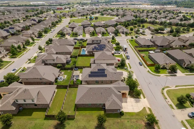 an aerial view of residential houses with outdoor space