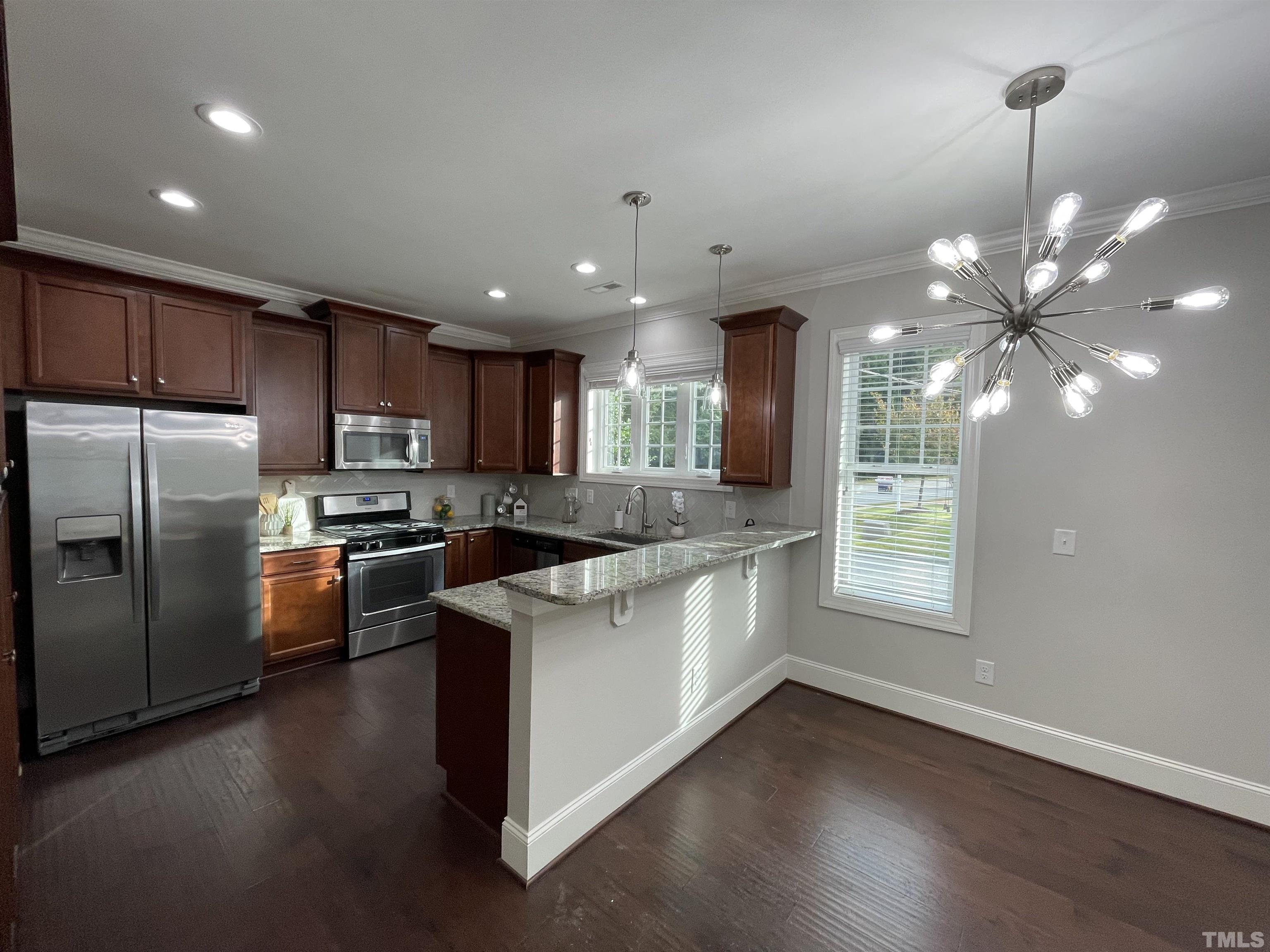 2820 Plumfield Place Raleigh, NC 27607 - Photo 2 of 23 a kitchen with stainless steel appliances granite countertop a sink a stove and a refrigerator