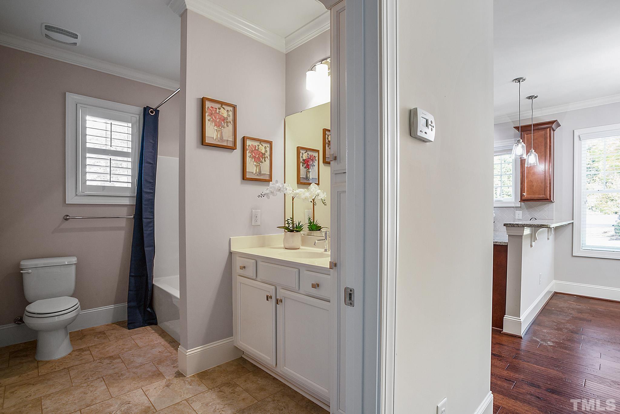 2820 Plumfield Place Raleigh, NC 27607 - Photo 17 of 23 a bathroom with a toilet sink and mirror