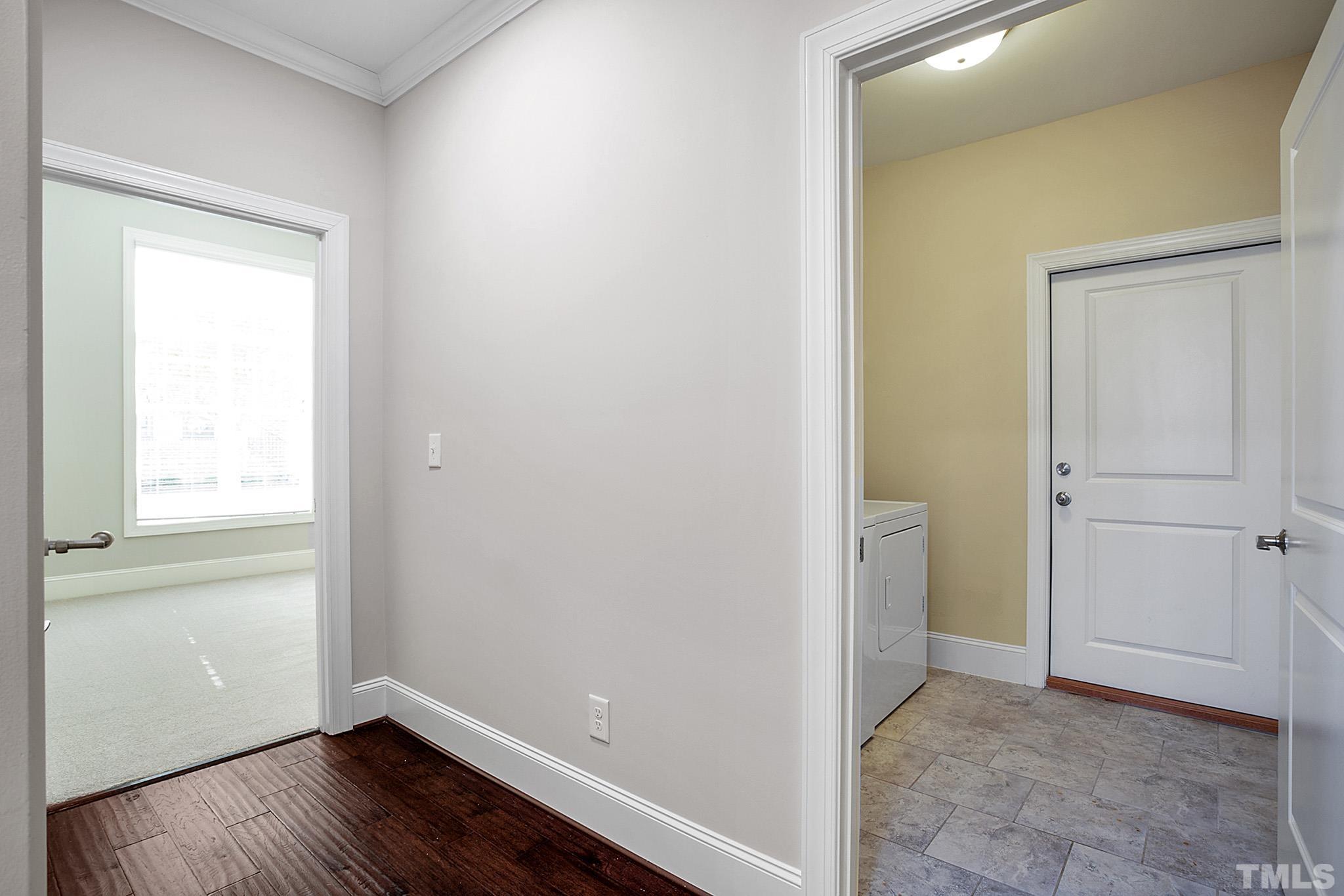 2820 Plumfield Place Raleigh, NC 27607 - Photo 19 of 23 a view of an empty room with wooden floor and a window