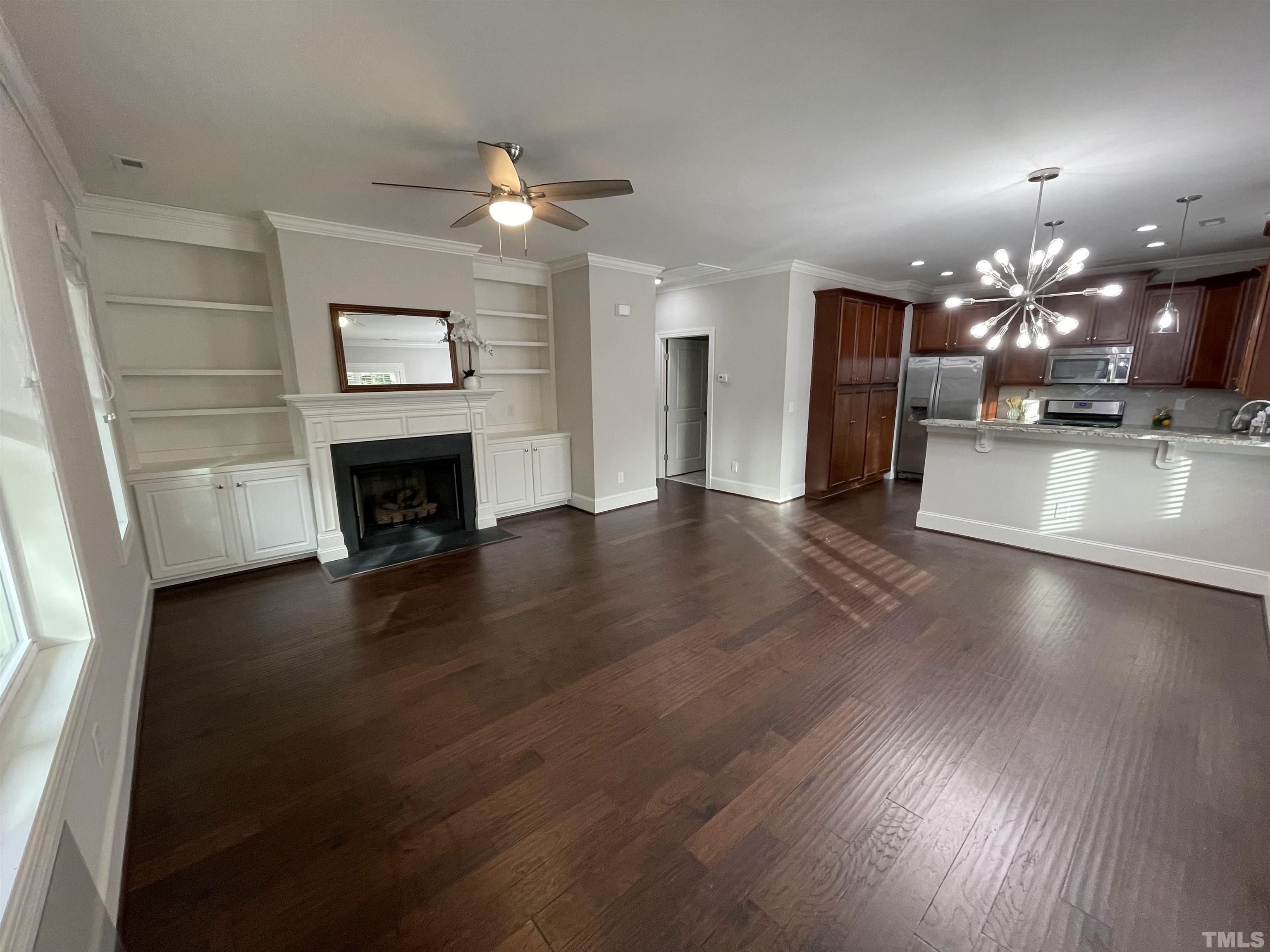 2820 Plumfield Place Raleigh, NC 27607 - Photo 3 of 23 an open kitchen with furniture and a fireplace