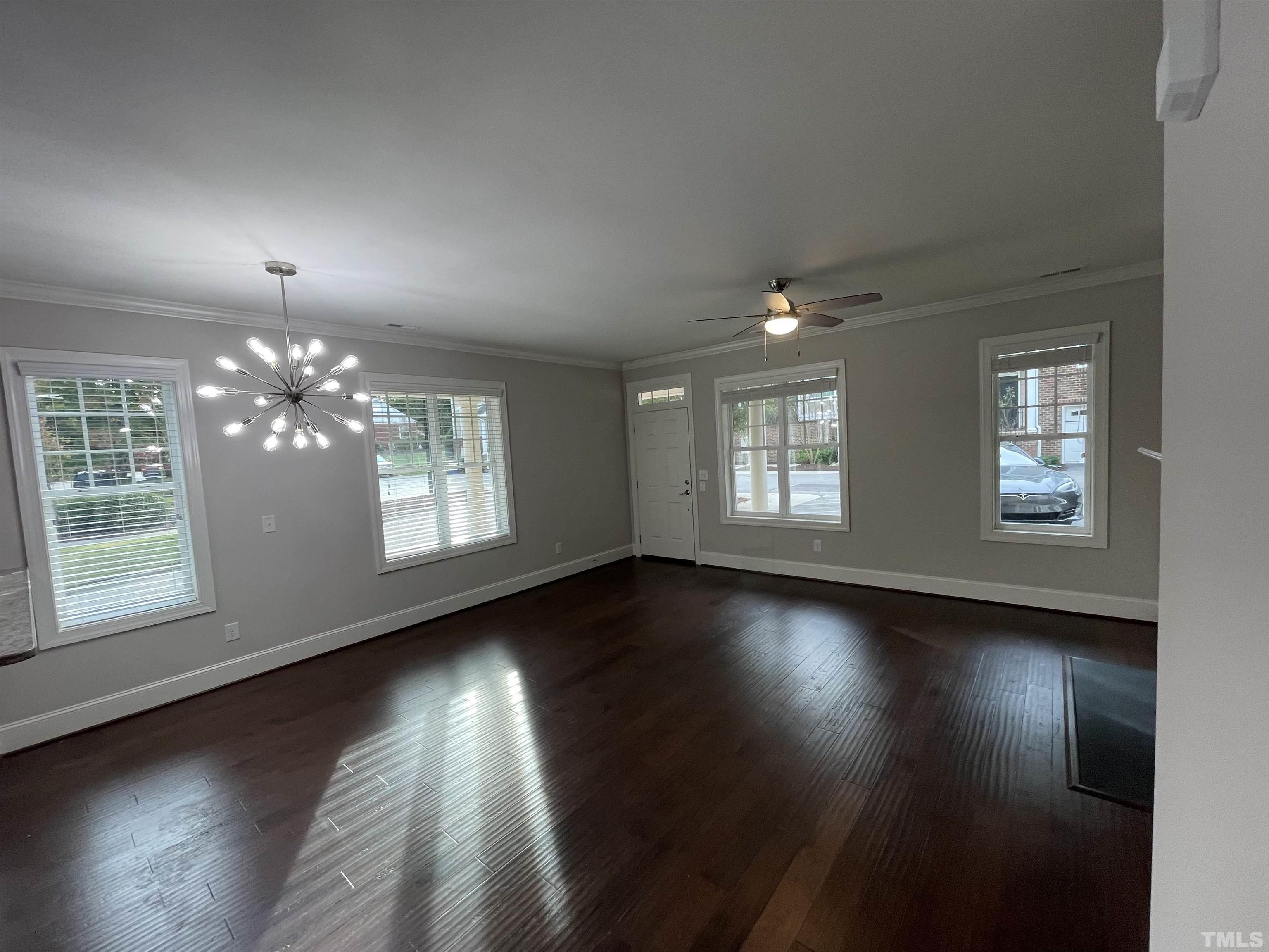 2820 Plumfield Place Raleigh, NC 27607 - Photo 4 of 23 an empty room with wooden floor and windows
