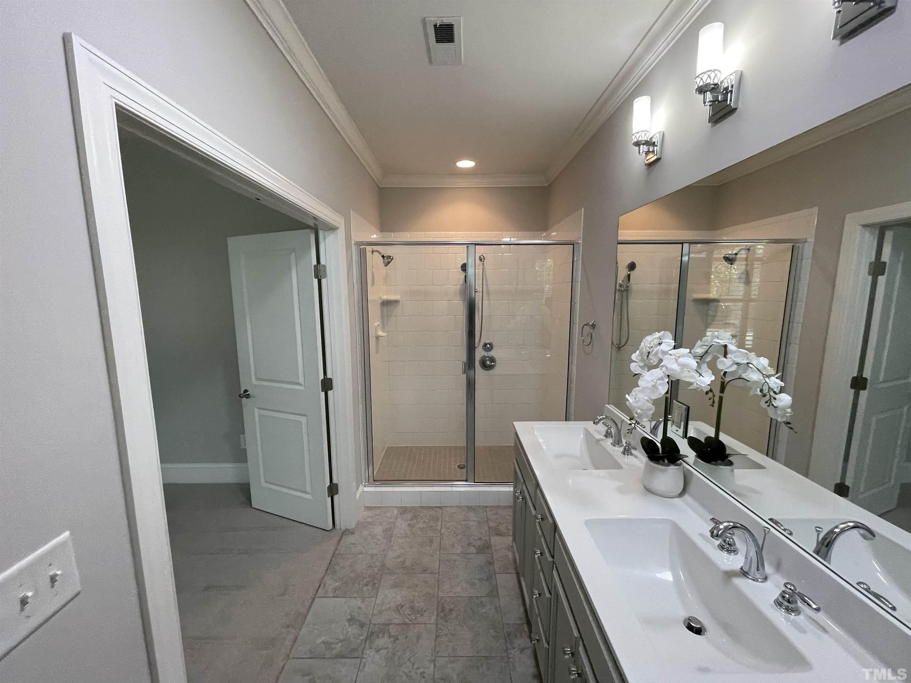 2820 Plumfield Place Raleigh, NC 27607 - Photo 8 of 23 a bathroom with a sink mirror and shower