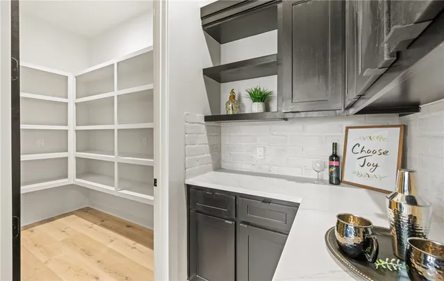 a view of a kitchen with fridge and rack