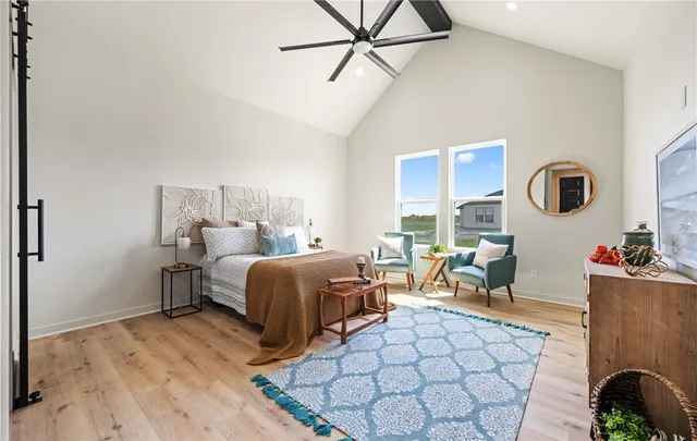 a bedroom with a bed and lamp with the wooden floor